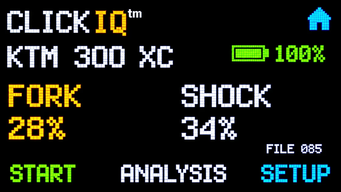 Actual ClickIQ touchscreen showing KTM 300 XC, fork travel 28 percent, shock travel 34 percent, battery indicator, and touch options START, ANALYSIS and SETUP.